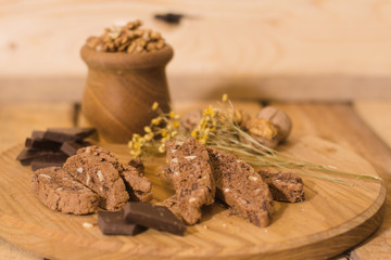 bread with candied fruit, chocolate and nuts close up picture, wooden table background