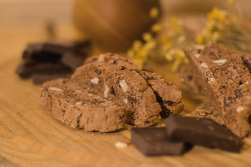 bread with candied fruit, chocolate and nuts close up picture, wooden table background
