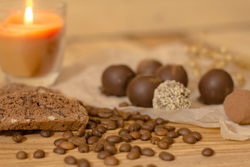 handmade chocolate candys on wooden table with chocolate bread and coffee bean decorations 