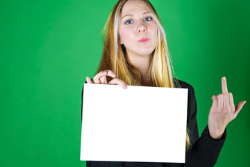 Attractive young blonde model holds an empty white card and shows a rude indecent gesture - middle...