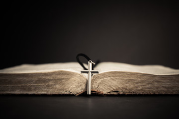 old books with cross. religion concept.