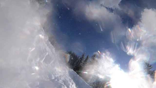 skier skiing off piste in difficult snow on open landscape between trees on sunny winter day selfie point of view falling 4K
