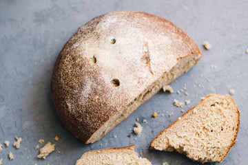warm, freshly rye bread. Cut the slices. Tear off a piece. top view. Farm food made from flour and eggs.