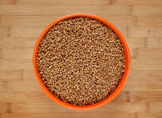 buckwheat groats in a bowl on a wooden table