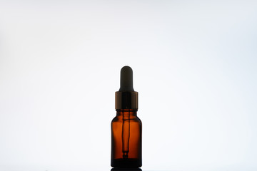 bottle of aromatic oil with pipette on white