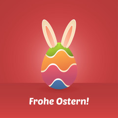 Obraz premium Ostergruß mit Osterei und Hasenohren in rot