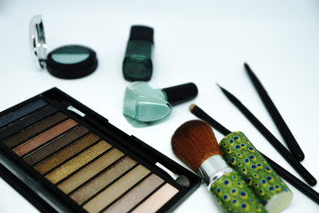 Make up brush and cosmetics isolated on white background.
