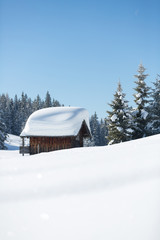 Winter ski cabin in snow mountain landscape. Austrian Alps