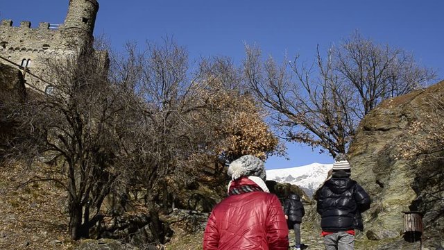 Ussel fraction of Chatillon, Valle d'Aosta, Italy 11 February 2018. Film of the path to climb to the medieval castle of Ussel. Tourists along the climb.