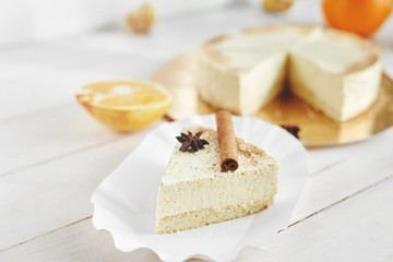 light diet Cheesecake with oranges and cinnamon on the white wooden background