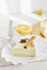 light diet Cheesecake with oranges and cinnamon on the white wooden background