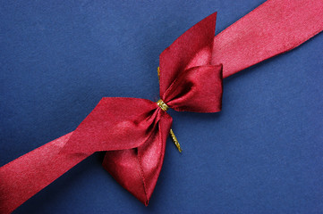 Blue Christmas gift box with red bow and ribbon