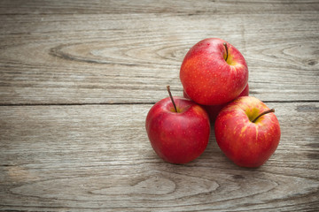 Red apples on a wooden table background