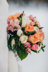 beautiful wedding bouquet with white and orange roses and pink alstroemerias on white background