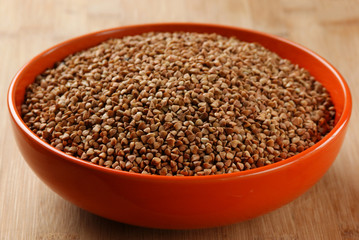 buckwheat groats in a bowl on a wooden table