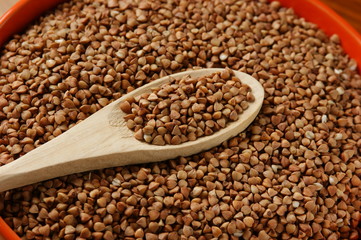buckwheat groats and wooden spoon