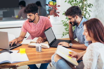 Group of multi ethnic young students preparing for exams in home interior.