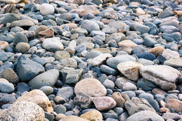 Stones, pebbles and sand on the shore of a mountain river