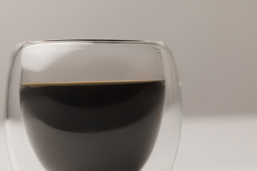 Close-up view of black coffee in cup on white background