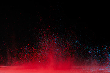 red holi powder explosion on black, traditional festival of colours
