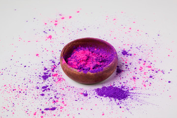 Fototapeta na wymiar purple and pink holi powder in bowl isolated on white