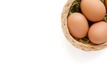 Eggs in the wicker basket on white background