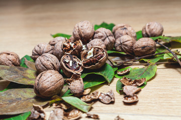 Several walnuts lie on brown background