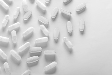 white pills on white background 