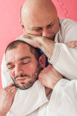 Brazilian jiu-jitsu training demonstration in traditional kimono © guruXOX