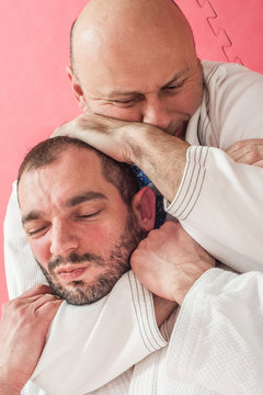 Brazilian jiu-jitsu training demonstration in traditional kimono