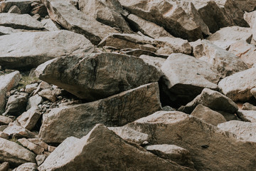 Stones and cobblestones close up. The rocks in the mountains.