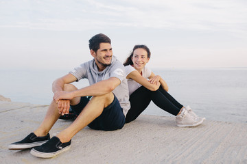 Smiling young couple relaxing outdoors.  Sport concept