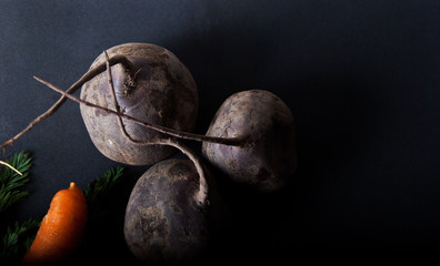 Three red beetroots with carrot