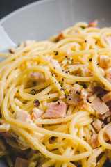 Tasty pasta with bacon and cheese. Selecitve focus.