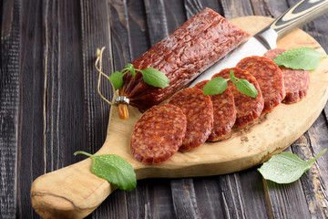Delicious salami with basil , selective focus