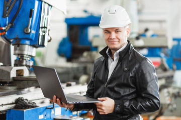 young engineer with laptop in hands