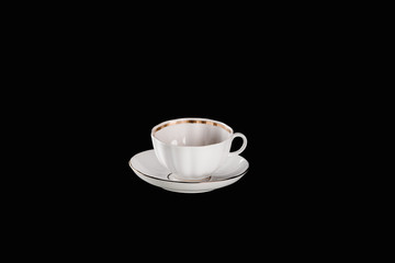 white cup and plate isolated on black