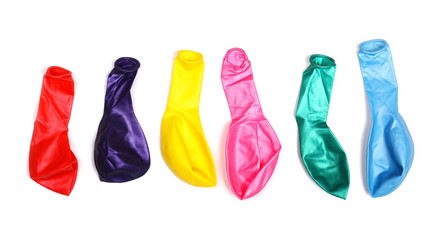 Pile of deflated colorful balloons, isolated on white background, top view