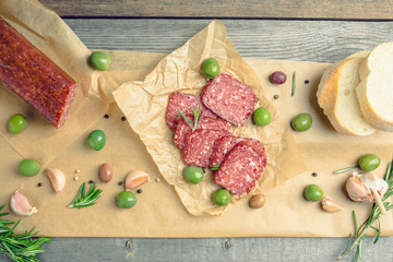 Delicious salami with olives, spices and rosemary. Selective focus.