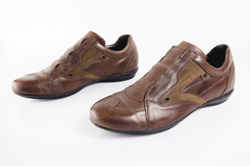 Male brown leather shoe on white background, isolated product, comfortable footwear.