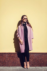 Summer sunny lifestyle fashion portrait of young stylish woman posing on street,wearing cute trendy...