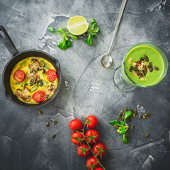 Healthy green smoothie with spinach, vegetarian omelet and pumpkin seeds. Flat lay, top view. Food frame background