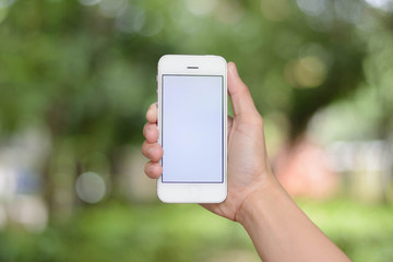 hand holding smartphone on abstract bokeh background