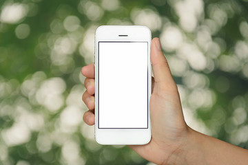 hand holding smartphone on abstract bokeh background