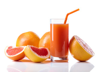 Glass of fresh grapefruit juice and cut fruits white background.