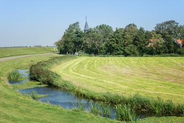 Church tower in a small village in the Frisian countryside in the Netherlands
