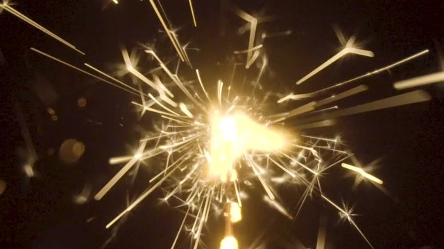 Firework sparkler burning on black background in slow motion