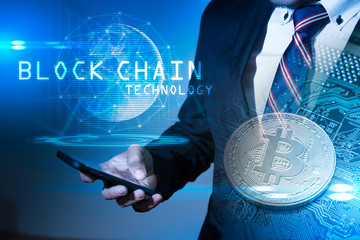 The double exposure image of business man hold the blockchain overlay with bitcoin image and element of this image furnished by Nasa. the concept of cryptocurrency, blockchain and internet of things.