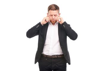 Fototapeta premium Portrait of young Caucasian businessman in black suit and white shirt posing on white background