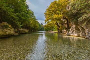 wild Acheron river in Greece with clouds and vegetation